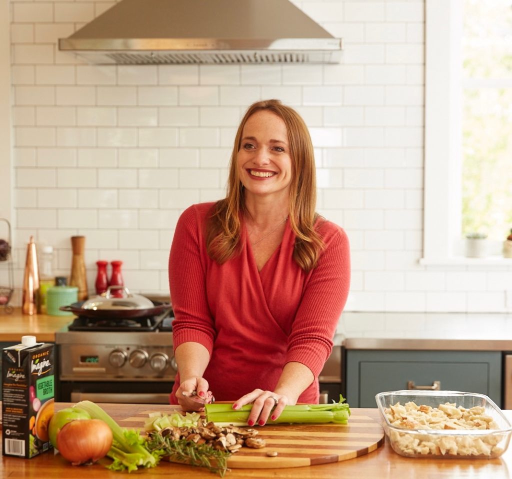 Nutritionist advisor Wendy Sterling, smiling and preparing food in her kitchen